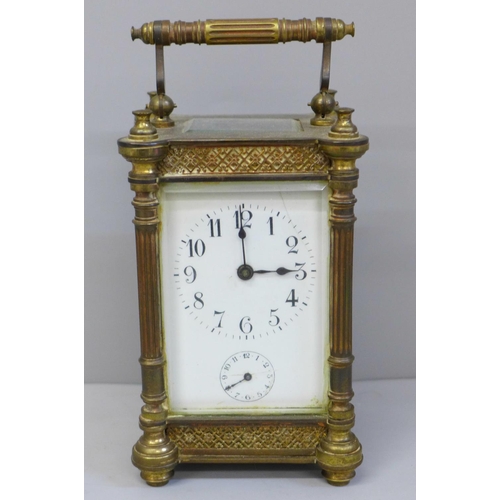 614 - An early 20th Century brass and four glass sided carriage clock with alarm