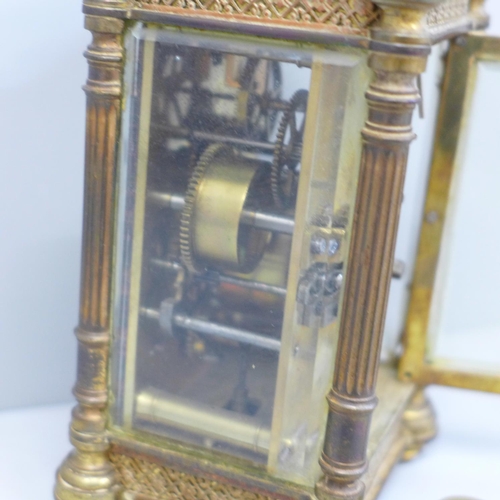 614 - An early 20th Century brass and four glass sided carriage clock with alarm