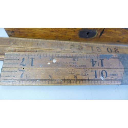 696 - A box containing old rulers and drawing instruments