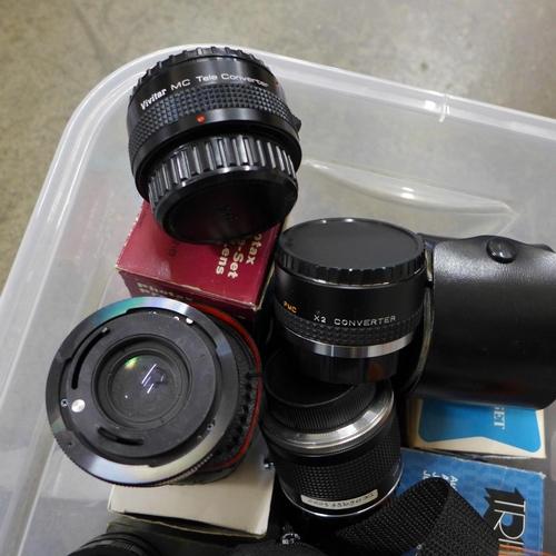 697 - A box of vintage flash cubes and a box of lens hoods and lens extension tubes