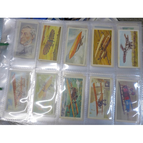 746 - A large collection of cigarette cards and tea cards in two trays, covering many themes, cards in set... 