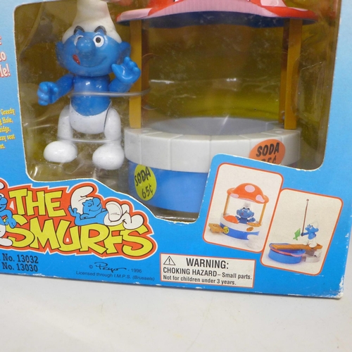 764 - Three unopened boxed and original 'The Smurfs' toys from 1996, Talking Flip phone, Daisy Wheel 2-in-... 