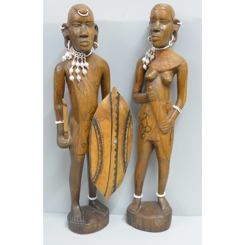 791 - Two African carved wooden figures with bead jewellery