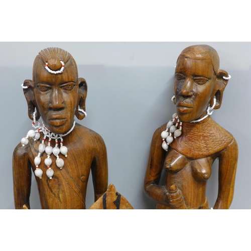 791 - Two African carved wooden figures with bead jewellery