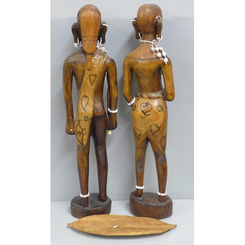 791 - Two African carved wooden figures with bead jewellery