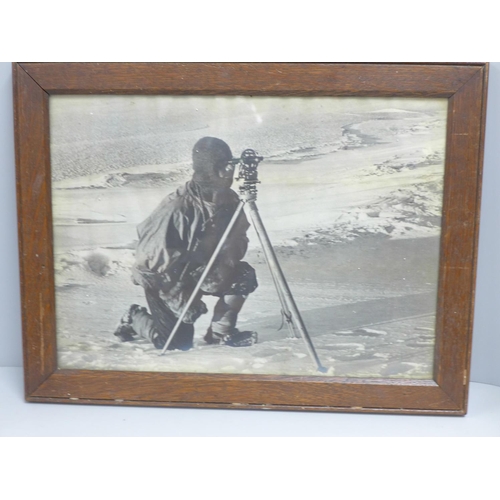 796 - An oak framed photograph of a Polar explorer - Captain Evans observing with the theodolite used by C... 