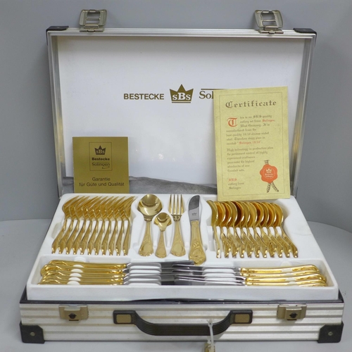 808 - A Solingen canteen of cutlery, gold tone