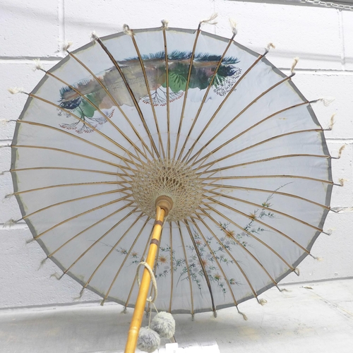 819 - A Japanese silk parasol in original tin-plate container