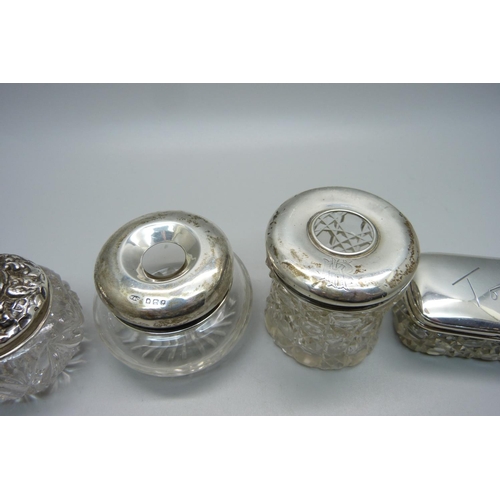 846 - Four silver top glass jars