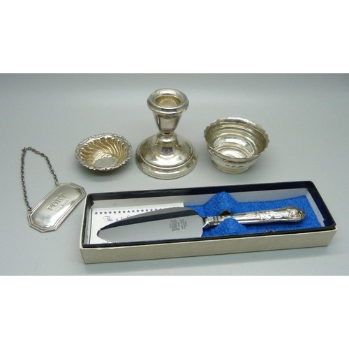 873 - Five silver items; Port label, two salts, candlestick and small silver handled server, weighable sil... 