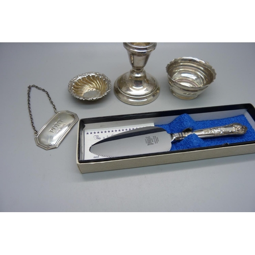 873 - Five silver items; Port label, two salts, candlestick and small silver handled server, weighable sil... 