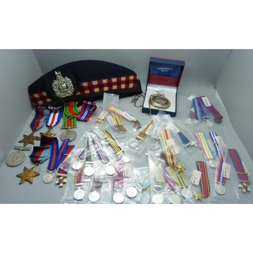 876 - Five WWII medals, a collection of replica miniature medals, a military cap, a badge and a pocket wat... 