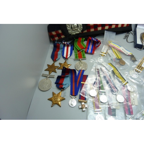 876 - Five WWII medals, a collection of replica miniature medals, a military cap, a badge and a pocket wat... 