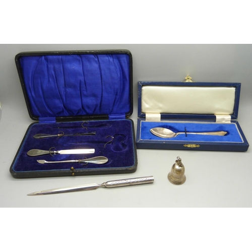 889 - A silver tooth fairy pot, a cased silver spoon, part manicure set and a letter opener with silver ha... 