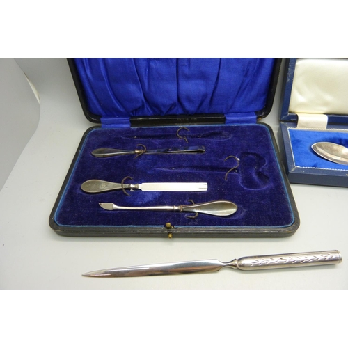 889 - A silver tooth fairy pot, a cased silver spoon, part manicure set and a letter opener with silver ha... 