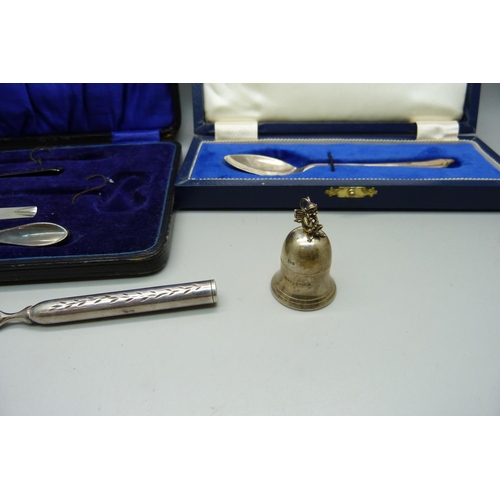 889 - A silver tooth fairy pot, a cased silver spoon, part manicure set and a letter opener with silver ha... 