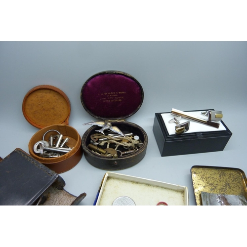 910 - Assorted items including clock and watch keys, a pair of gentleman's cufflinks, a bicycle repair kit... 