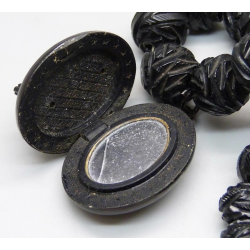 934 - A Victorian carved jet bead necklace with locket