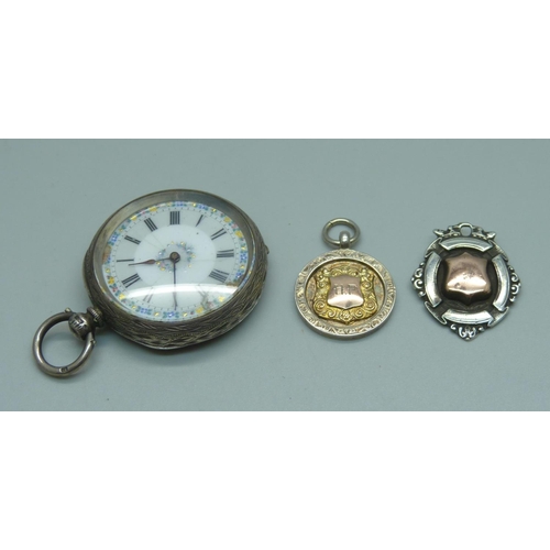 939 - A silver pocket watch, 4cm case, and two gold fronted silver fob medals