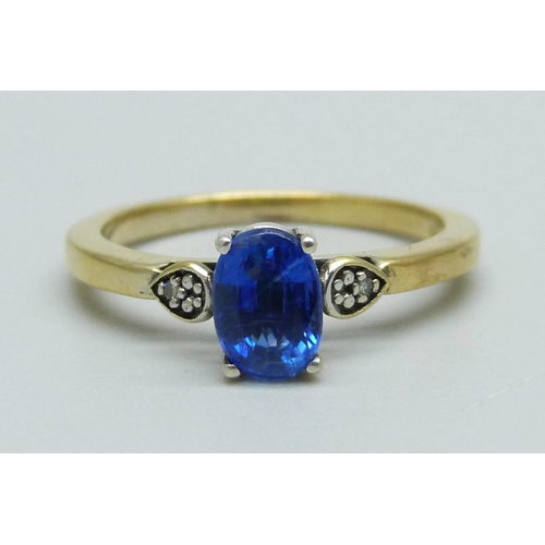 946 - A silver gilt and blue stone ring set with two small diamonds, N