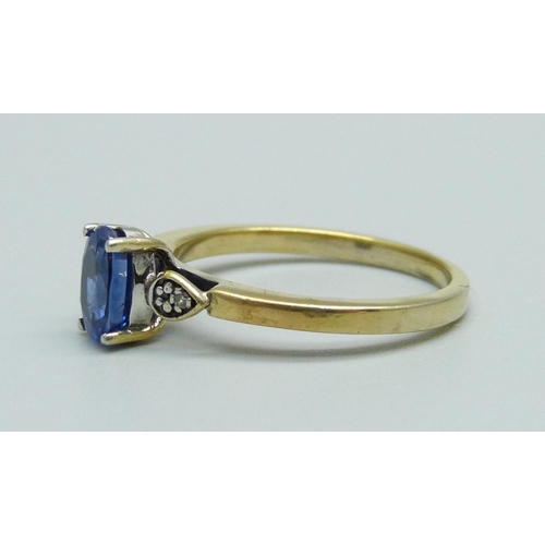 946 - A silver gilt and blue stone ring set with two small diamonds, N