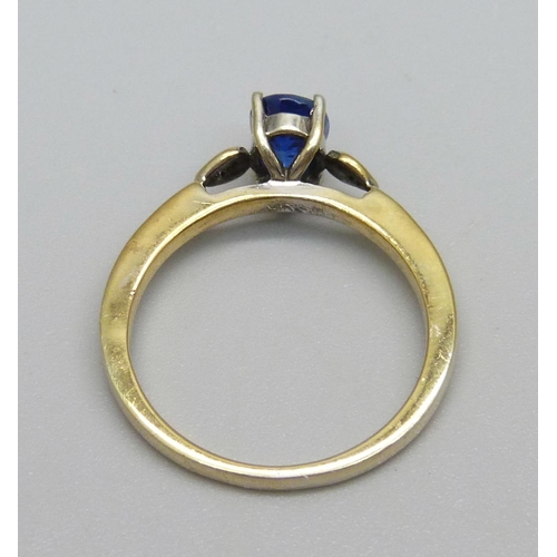 946 - A silver gilt and blue stone ring set with two small diamonds, N