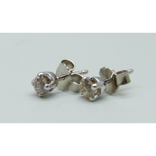 976 - A pair of 18ct white gold and diamond set stud earrings, total diamond weight 0.64cts