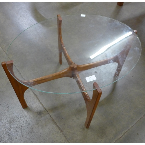 10 - A teak and glass topped oval coffee table