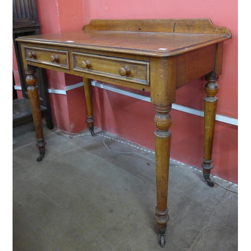 110 - A Victorian mahogany two drawer writing table