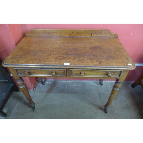 110 - A Victorian mahogany two drawer writing table