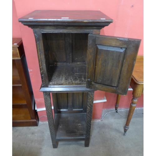 111 - An Elizabethan Revival carved oak cabinet on stand