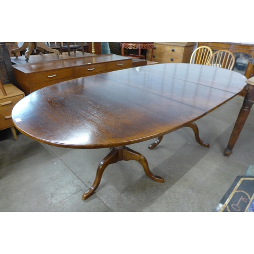 117 - An George III style elm pedestal dining table