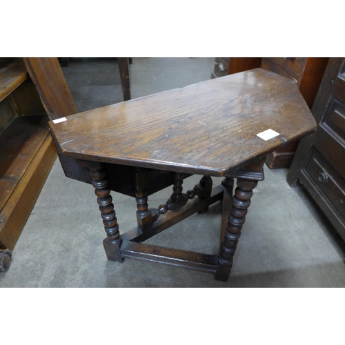 145 - A 17th Century style oak drop leaf gateleg occasional