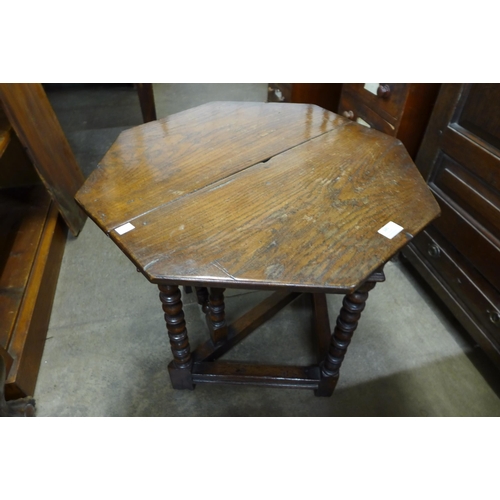 145 - A 17th Century style oak drop leaf gateleg occasional