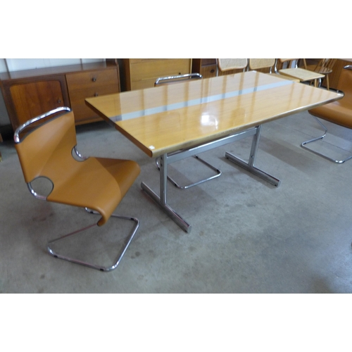 15 - A teak and chrome dining table and four chrome and brown faux leather cantilever chairs