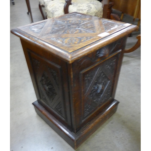 150 - A Victorian Jacobean Revival carved oak purdonium