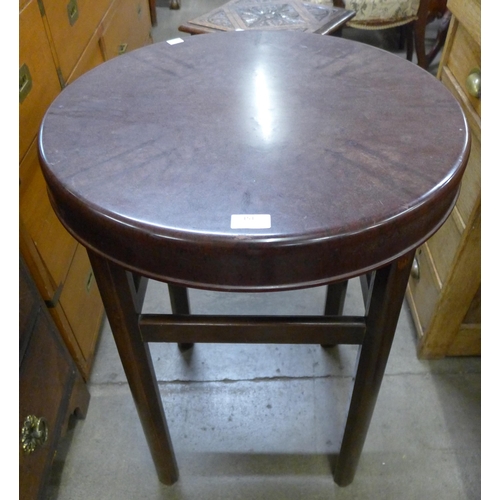 151 - An elm and Bakelite circular occasional table