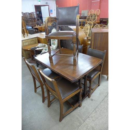 157 - An oak seven piece dining suite, comprising; draw leaf table, four chairs and a sideboard