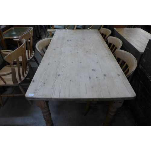 159 - A pine farmhouse kitchen table and six beech chairs