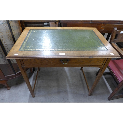 170 - An Edward VII oak and green leather topped single drawer writing table