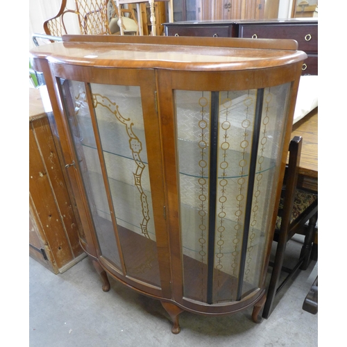 171 - A walnut bow front display cabinet