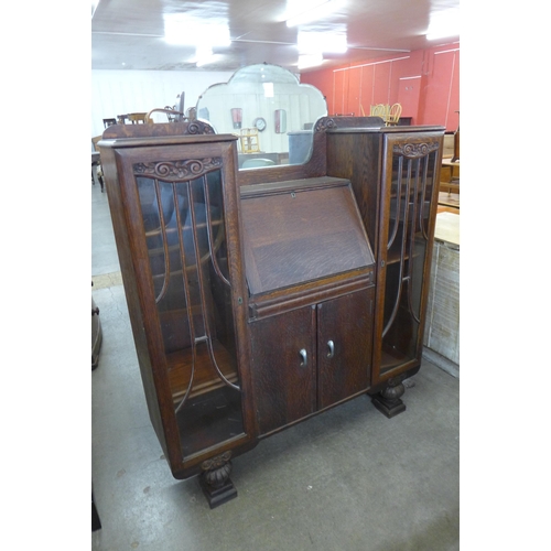 172 - An early 20th Century carved oak side by side bureau bookcase