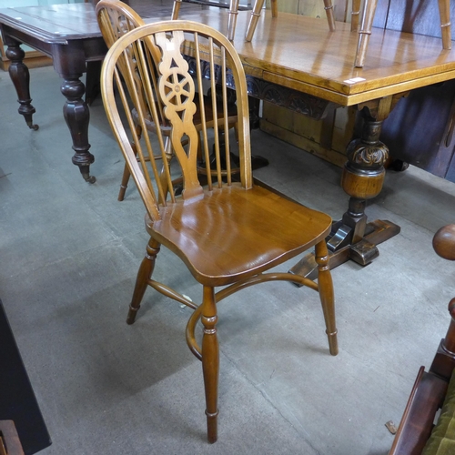 191 - A carved oak draw leaf refectory table and four beech wheelback chairs