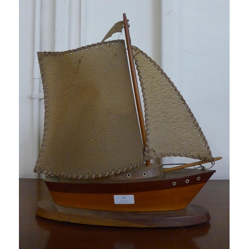 21 - A teak boat shaped table lamp