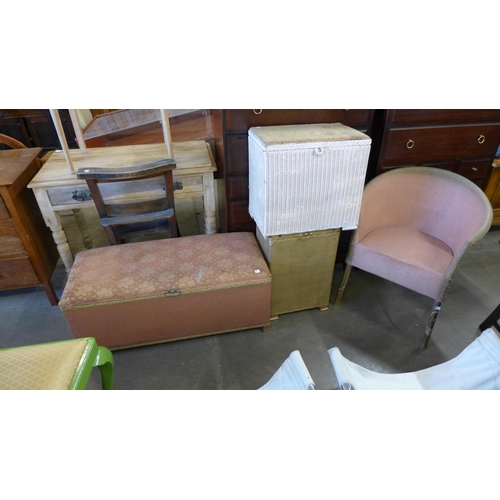 218 - A wicker armchair, two linen boxes and an ottoman