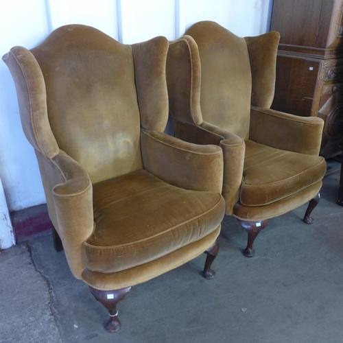 234 - A pair of early 20th Century Queen Anne style mahogany and fabric upholstered wingback armchairs