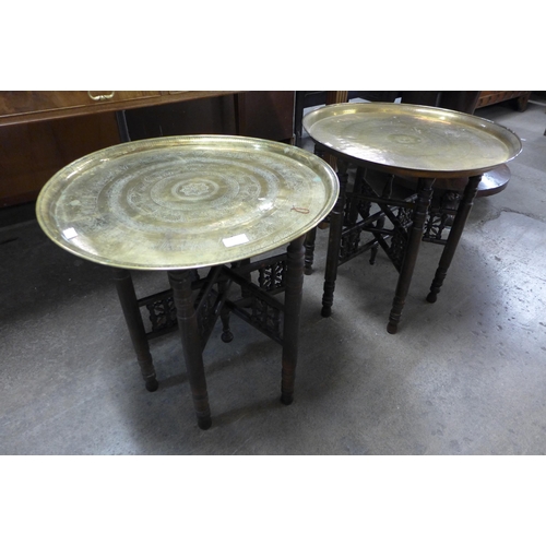 240 - Two Eastern brass topped folding occasional tables