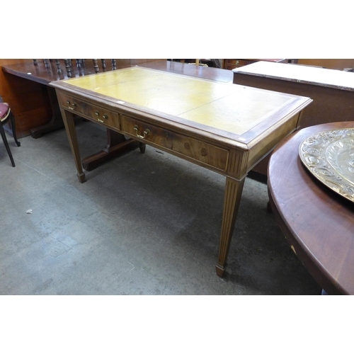 241 - A mahogany and leather topped two drawer writing table