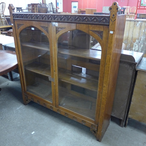 243 - A Victorian Aesthetic Movement oak two door bookcase