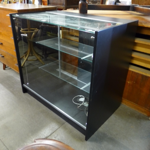 266 - An ebonised effect shop cabinet